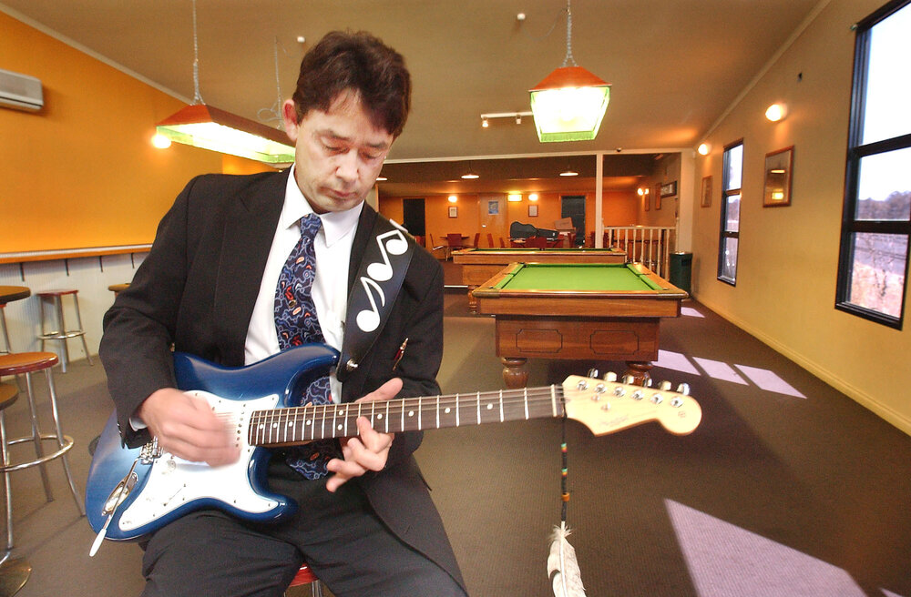 Unidentified man playing an electric guitar, Redbank, September 2003