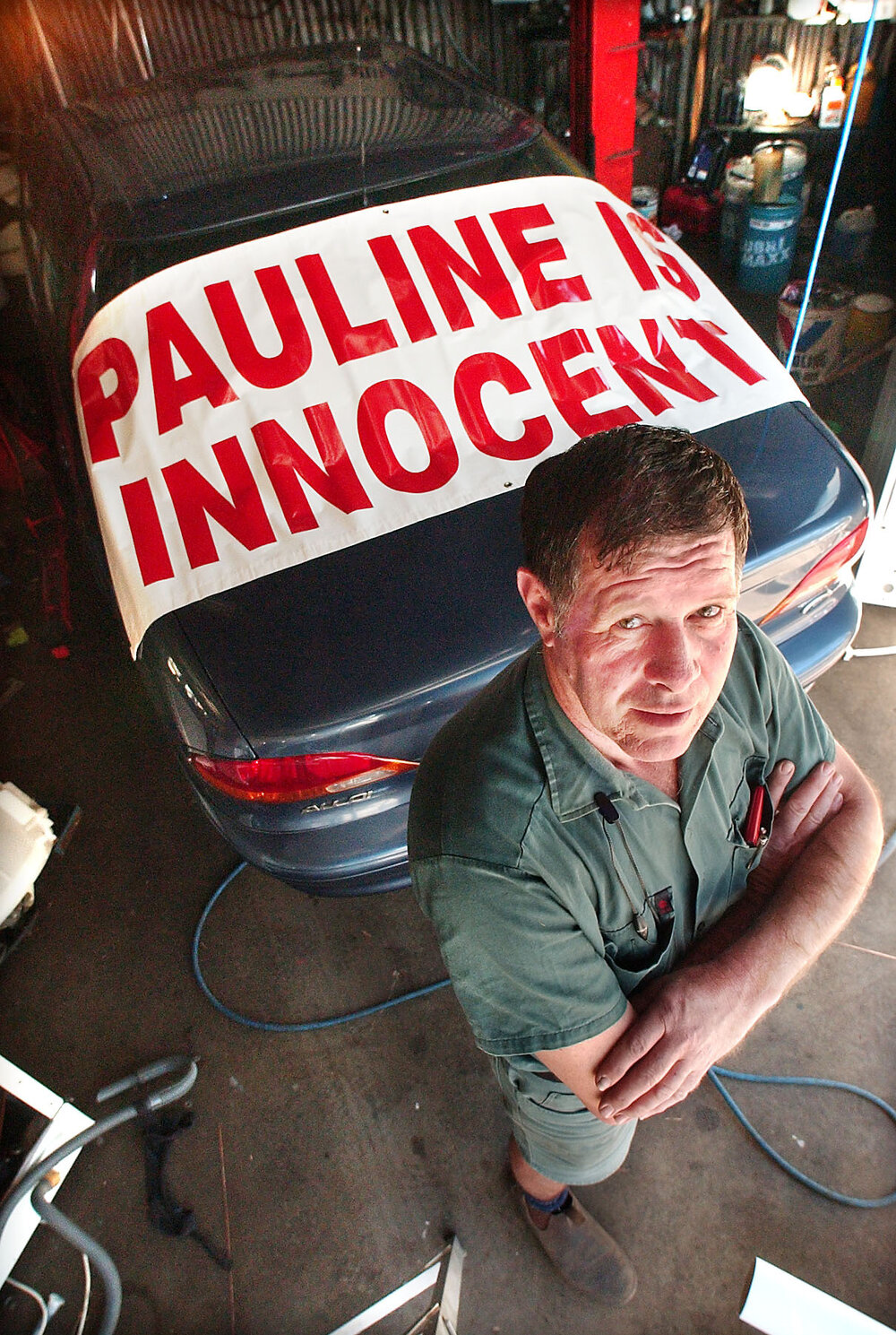 Geoff Walkden showing off a banner on a car about Pauline Hanson, Ipswich, September 2003