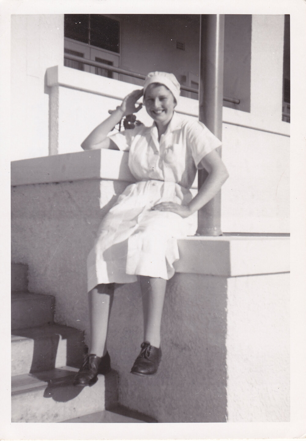 Nurse Lyn Berlin on the steps of Trumpy House, Ipswich General Hospital, Ipswich, 1950s