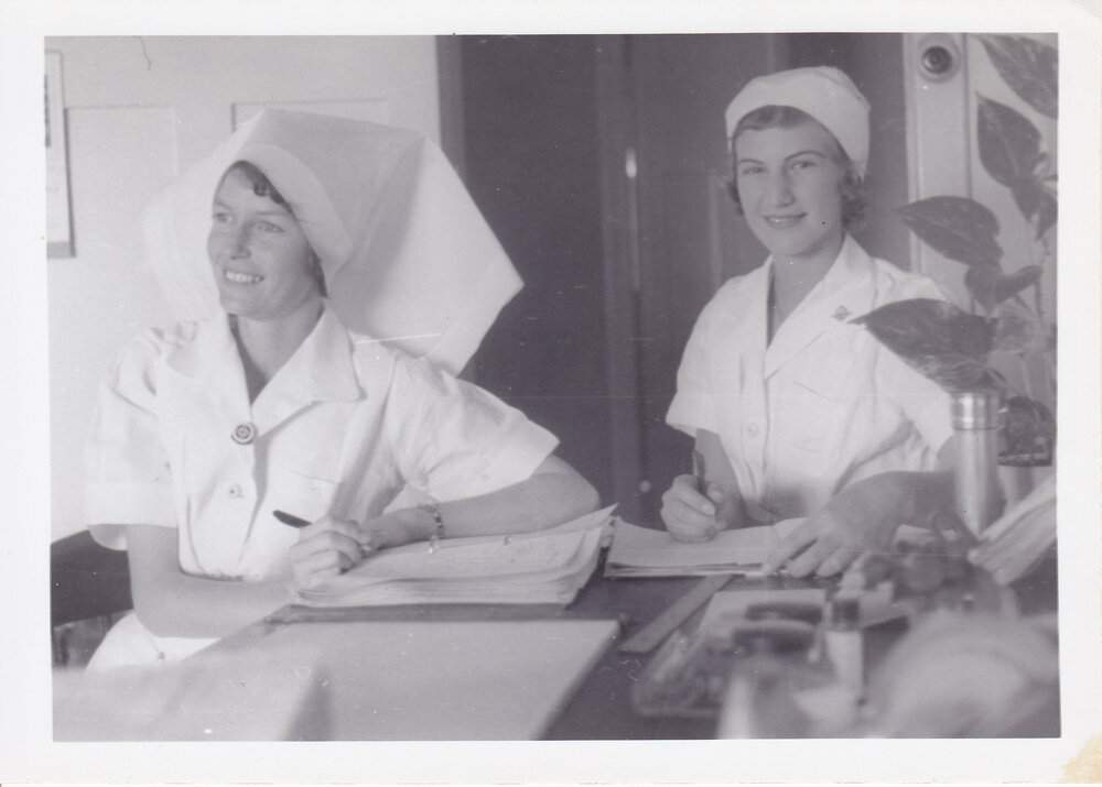 Nurses J Donald and R Herman completing documentation in ward, Ipswich Hospital, Ipswich, 1950s