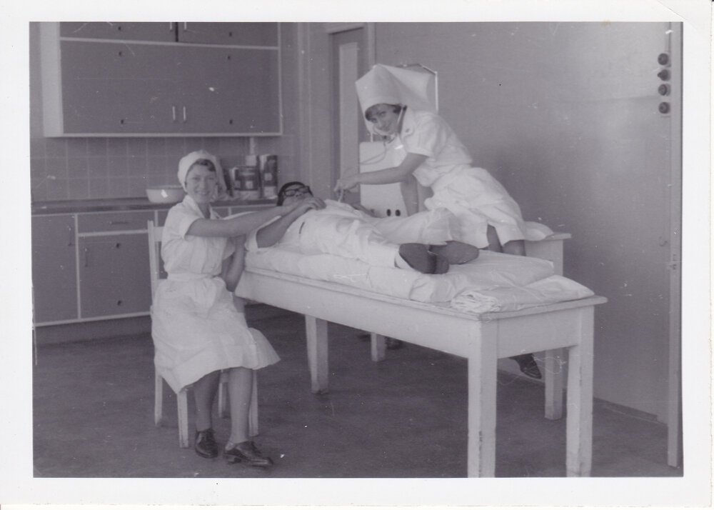 Nurses D. Pocock, P. Devereaux and Dr Chong Wah in treatment room, Ipswich General Hospital, 1950s 