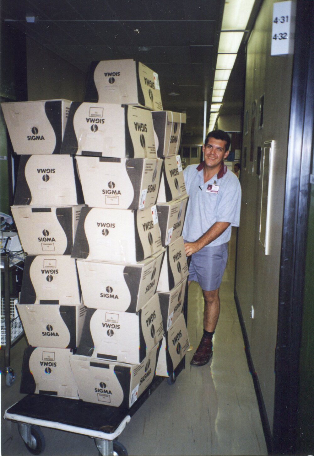 Store person delivering supplies in boxes to ward , 