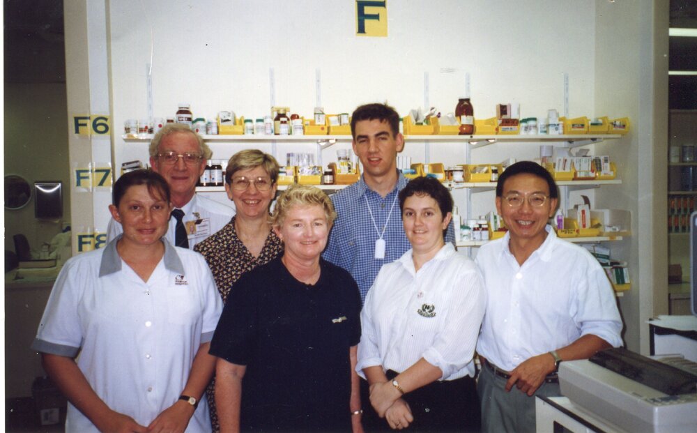 Pharmacy Staff, Back Row-Neville, Lynn Carl. Front Row-Rina, Sally, Angela, Bob, 1990s