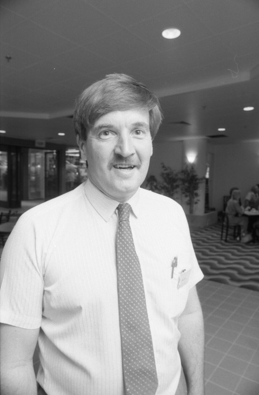 Unidentified man standing in a dining area at the opening of Ipswich City Square, Ipswich, August 1987 