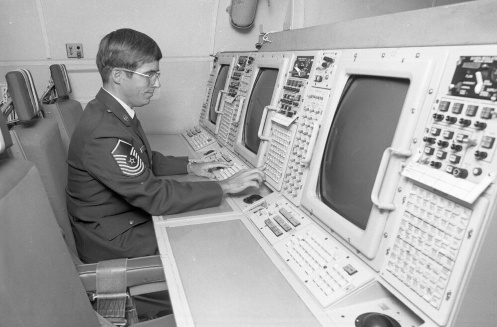 Airman working at a control console in the interior of a RAAF plane, Amberley Air Base, Amberley, Ipswich, September 1980