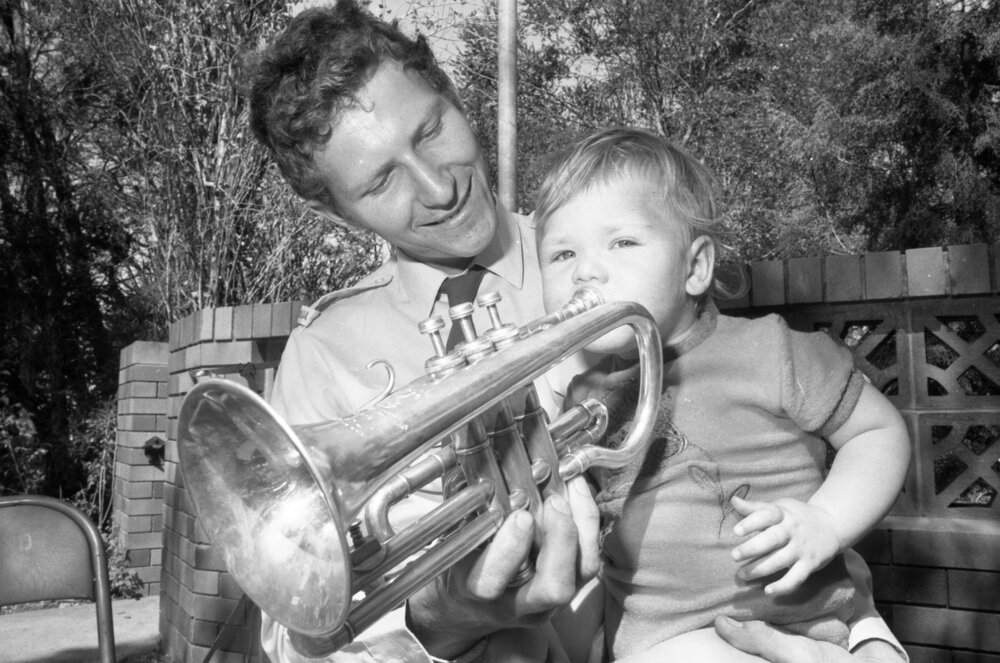 Trumpetist in the RAAF Band with a small child at St. Paul's Anglican Church, Ipswich, September 1980