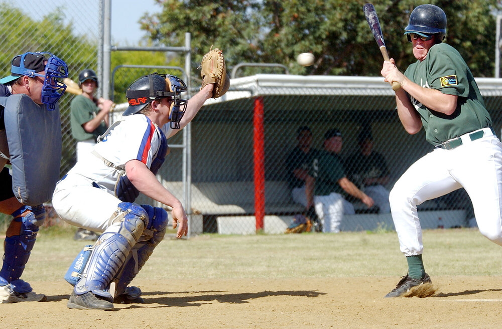Beenleigh batter Brett Montgomery and Musketeers catcher Aaron Blackburn playing baseball, Ipswich, September 2003