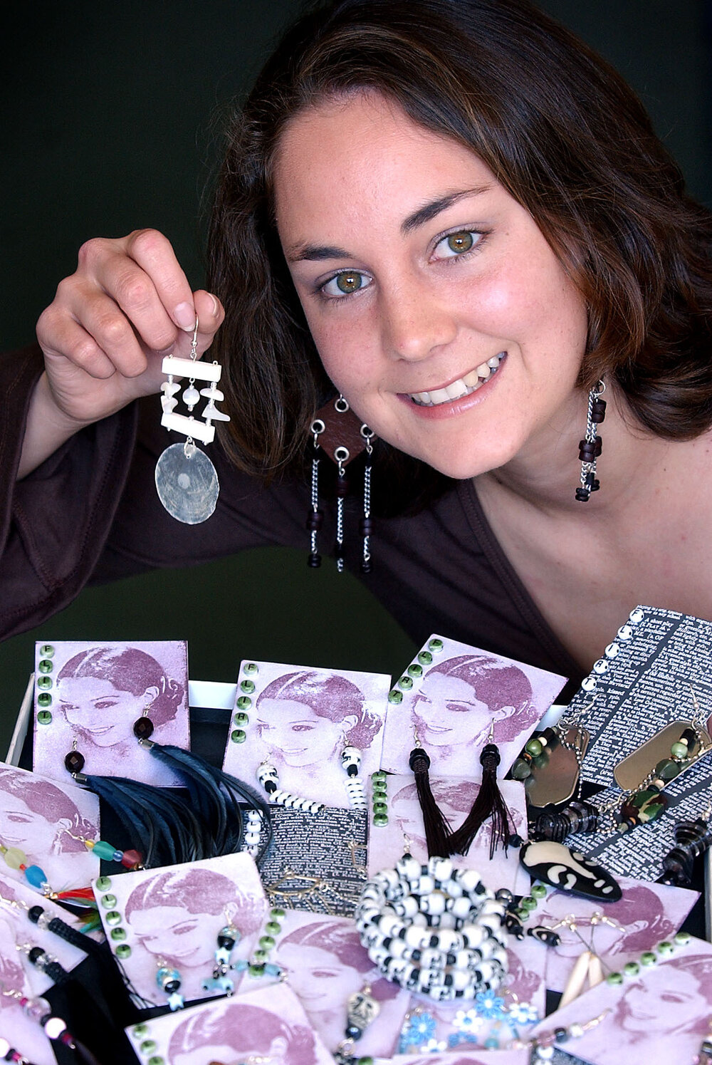 Ennette Cooper showing off her earring designs, Ipswich, September 2003