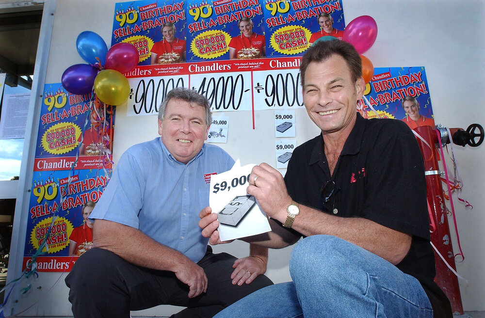 Chandlers Booval store owner Dan Ryan with competition winner Greg Weier, Booval, June 2003
