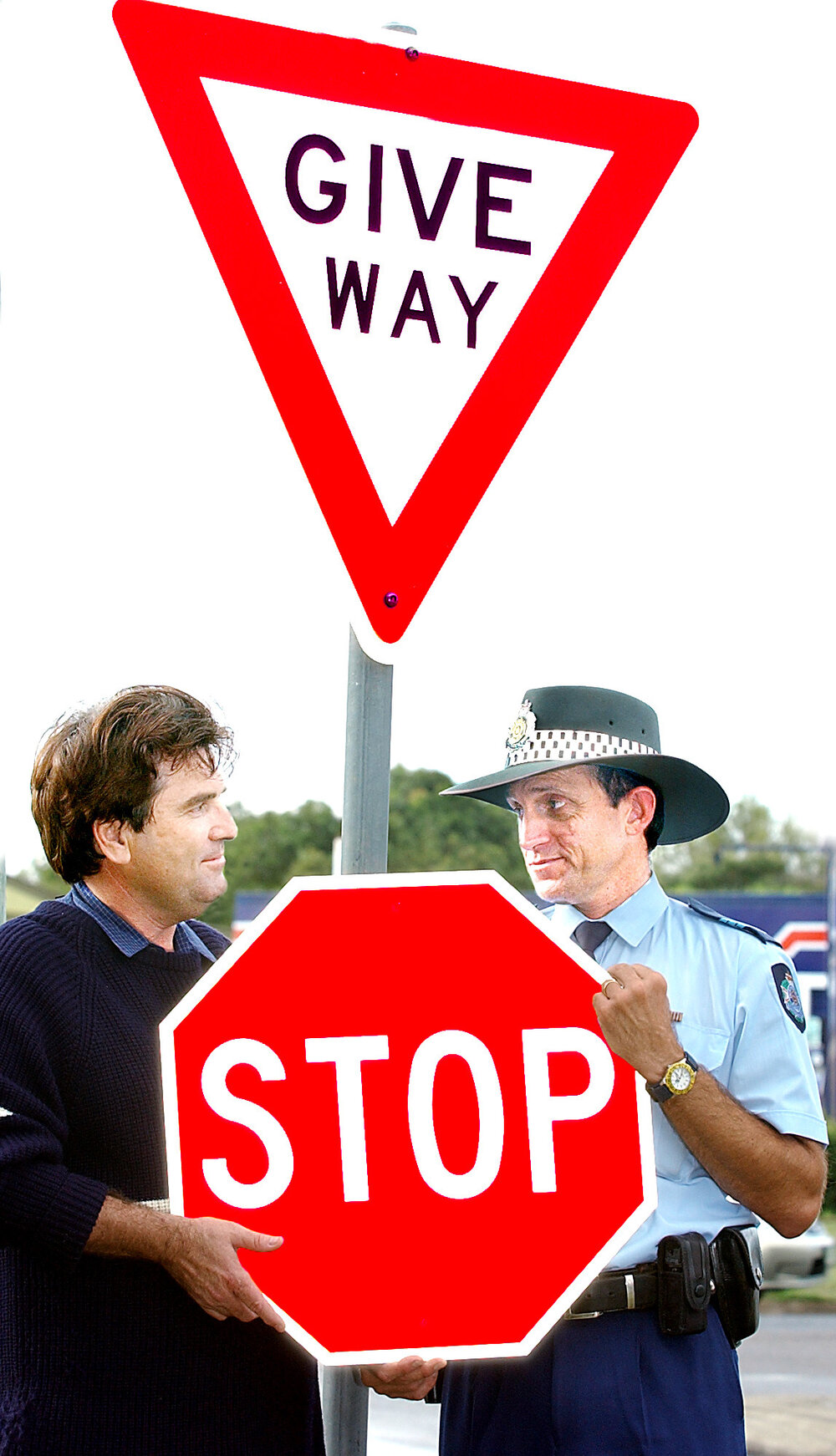 Unidentified man and police officer holding up a stop sign at the Whitehill intersection, Ipswich, June 2003