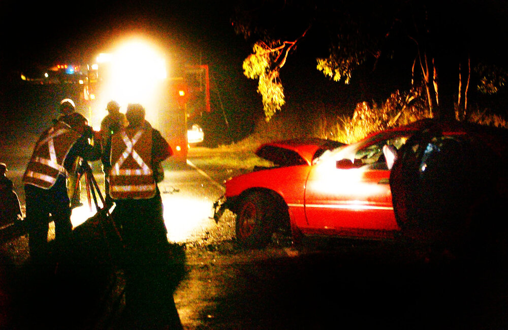 Firefighters working at the scene of a car accident on Redbank Plains road, Ipswich, June 2003