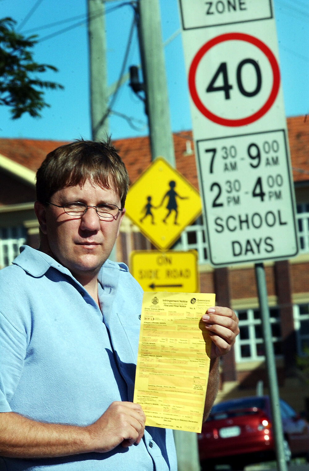 Les Bounds holding a speeding fine ticket at North Ipswich School Zone, Ipswich, June 2003