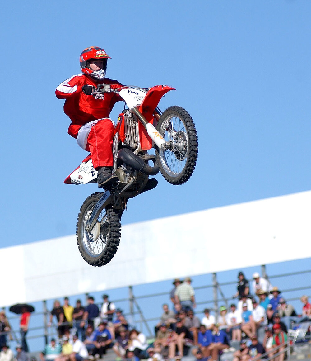 Motorcycle stunt riders entertaining spectators during racing break, Ipswich, June 2003