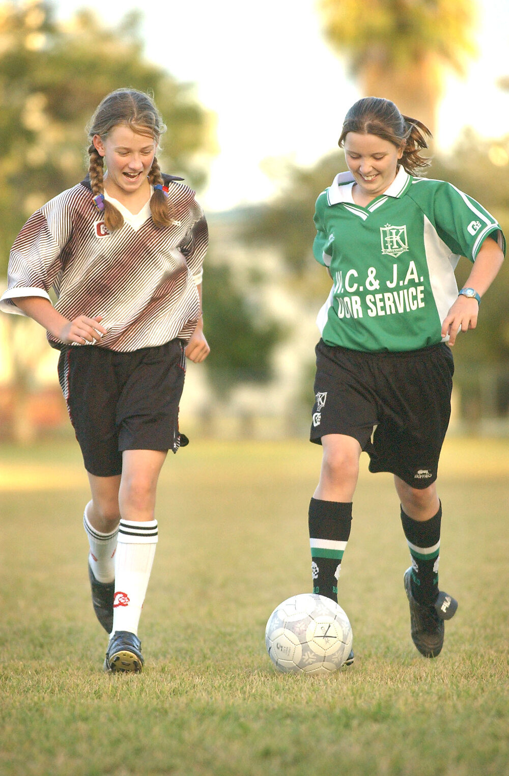 Janiene Smith and Teagan Essom playing soccer, Ipswich, June 2003