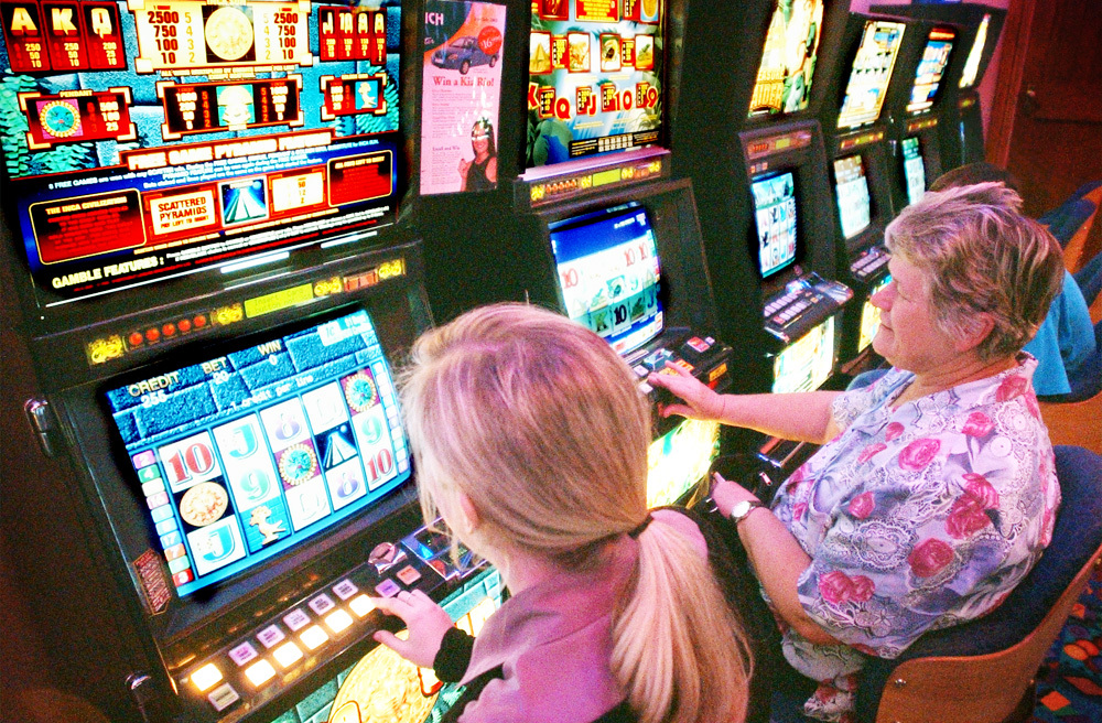 Wendy Westcott playing with a slot machine, Ipswich, June 2003