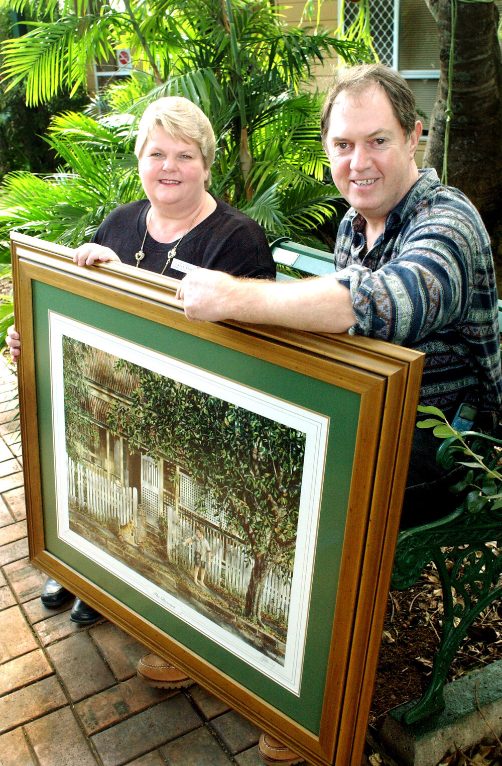 Gayle Brockie and Gordon Hanley holding a painting at an art auction, Ipswich, June 2003