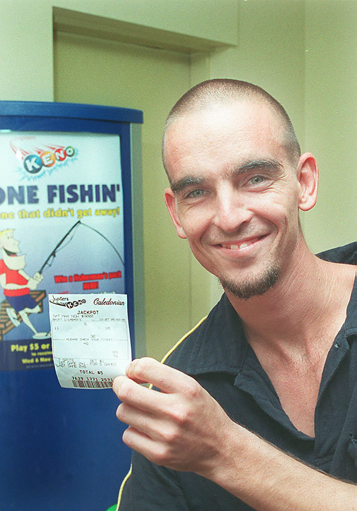 Unidentified man holding a jackpot ticket, Ipswich, February 2003