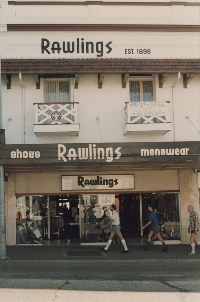 Pedestrians walking past Rawlings shopfront, Brisbane Street, 1990s