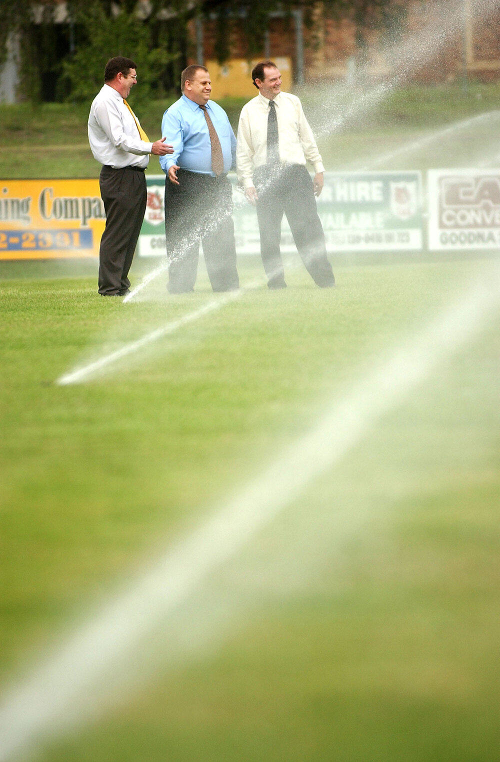 Three unidentified men at the Bendigo Bank oval, Ipswich, February 2003