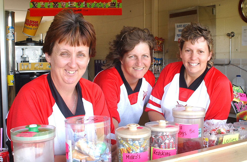Lauren McComb, Janelle Weller and Janelle Ziebath watching vigoro matches from the canteen, Ipswich February 2003