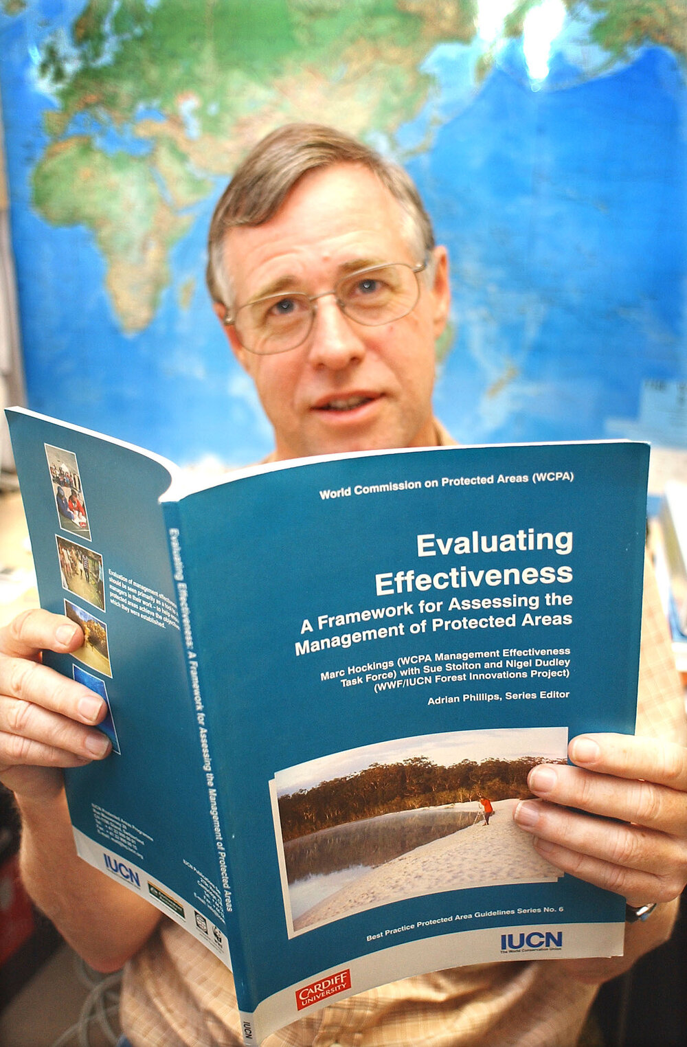 Marc Hockings reading a book on wildlife at the University of Queensland, Gatton, March 2003