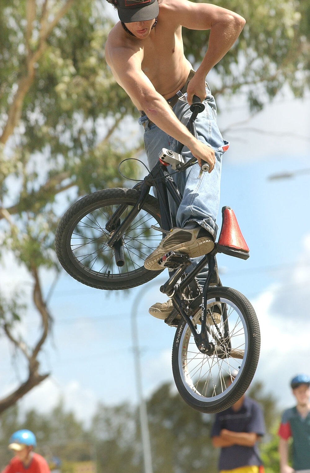 Clint Ford, "Jabba" and  "Big Matt" doing bike tricks on BMX bikes at the skatebowl, Brisbane Road, Bundamba, Ipswich, March 2003