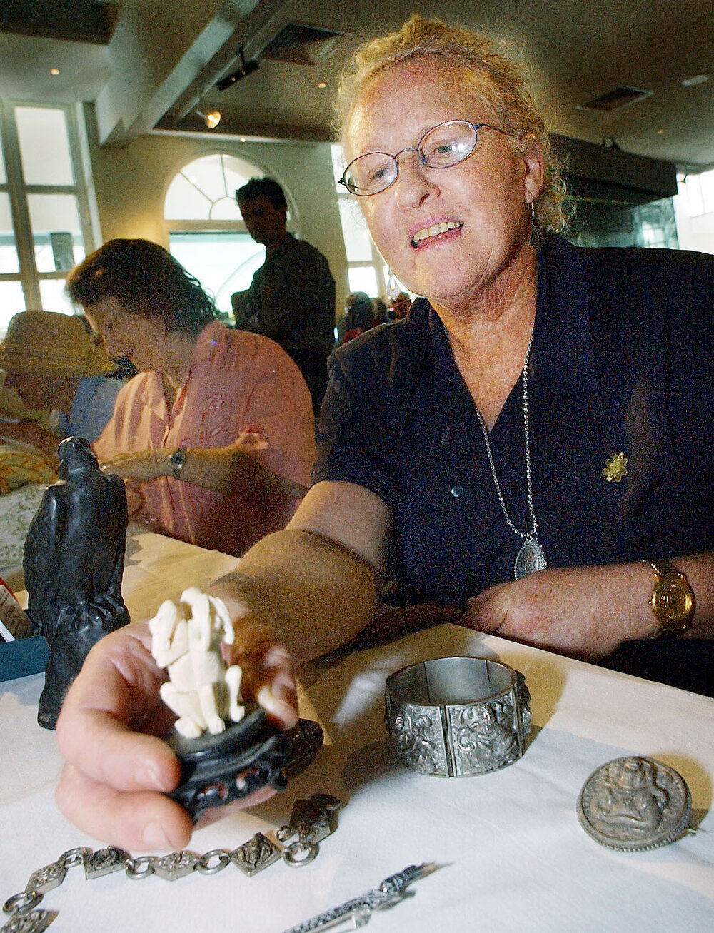 Christine Lloyd admiring collection of Chinese silver and holding a bone carving at Ipswich festival, Ipswich April 2003