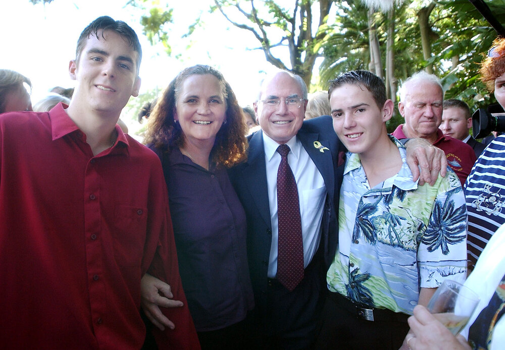 Thought to be an unidentified Ipswich family with Prime Minister John Howard, April 2003  