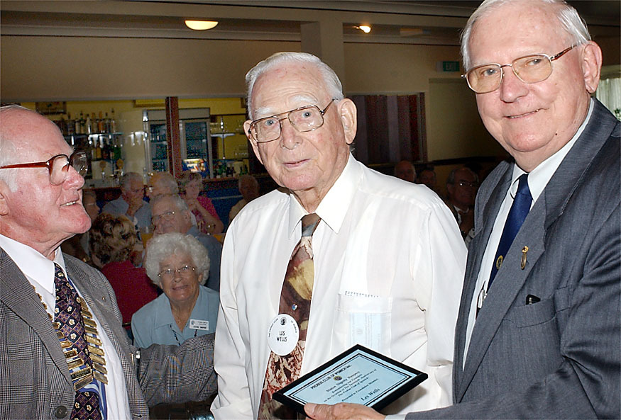Les Wells (centre) being presented with a Foundation member plaque by Bob Rogers at the Probus 20th Anniversary luncheon held at the Brothers Leagues Club, Ipswich, April 2003