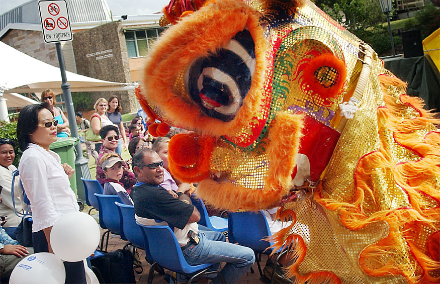Lion dancers and performers from the Southern Shaolin Wushu Academy moving through the crowd at the multicultural festival, Ipswich, April 2003