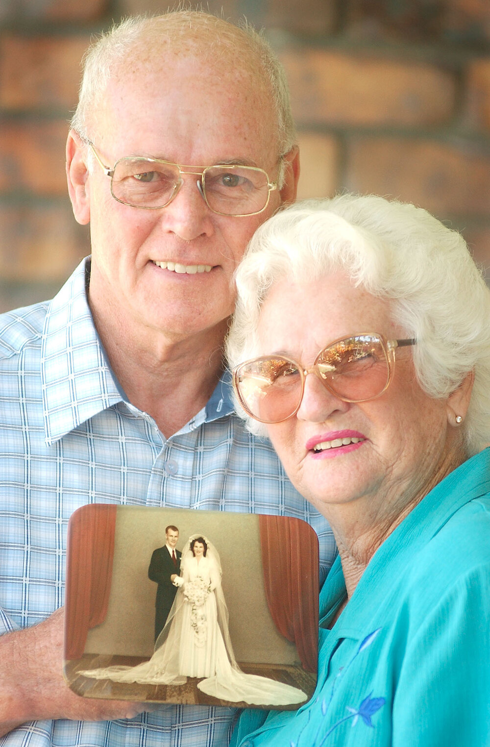 Jeff and Peg Newton with their wedding photo on their 50th wedding anniversary, Ipswich, April 2003