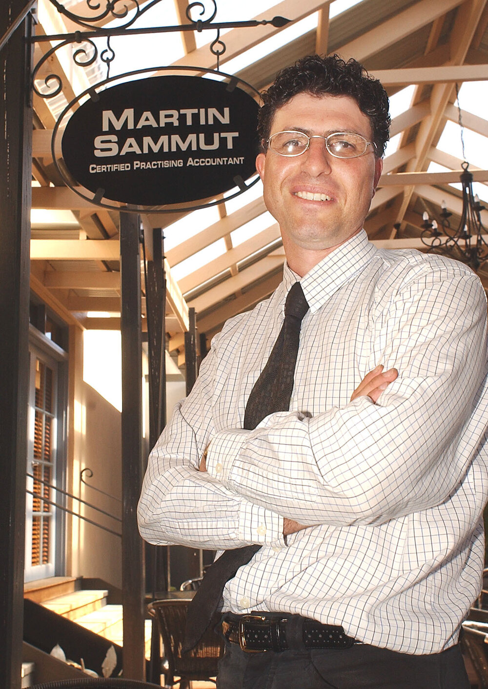 Martin Sammut in front of his accounting firm sign, Ipswich, November 2003