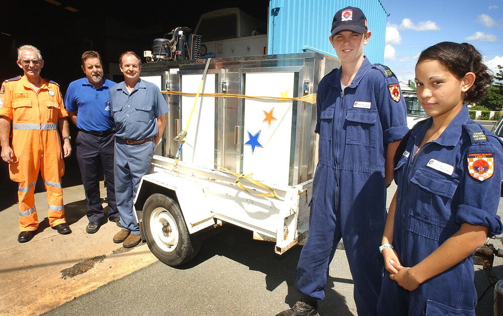 SES worker Jim Cooper, Lincoln Ison and Kelly Reedy,  Grag Neale of Neale's Electric and Peter Northrop of Llewellyn's and Co with the donated fridge by Llewellyn's and Co for the Ipswich SES Cadets, Ipswich, November 2003