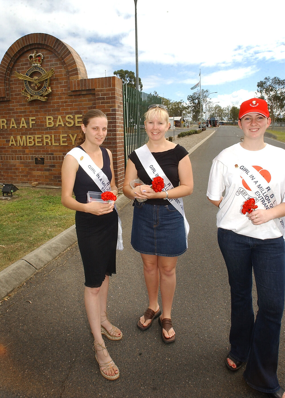 RSL Girl in a Million entrants, Tara Tate, Maree Lutter and Katie Smith, selling poppies before Remembrance Day at the front gate of RAAF Base Amberley, Ipswich, November 2003