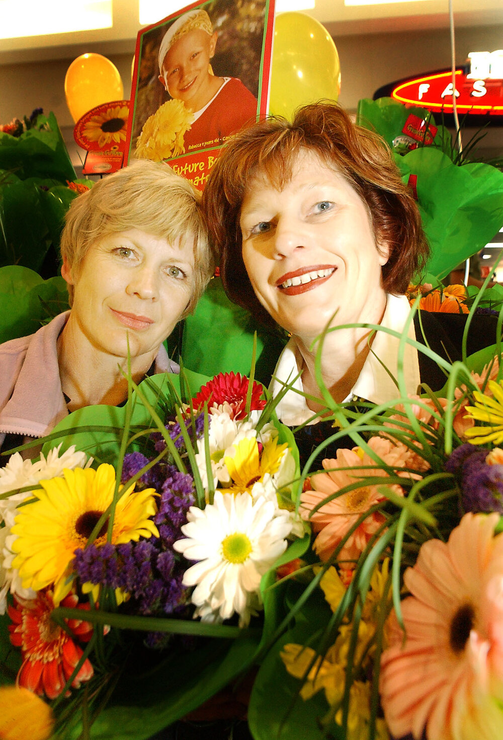Glyn Lewis and Colleen Bayliss of Brassall Woolworths selling flowers for Fresh Futures, Ipswich, August 2003
