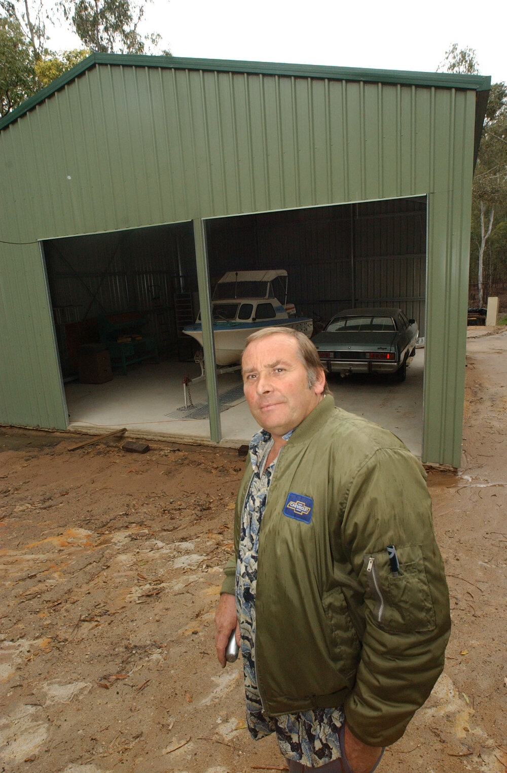Trevor Aylott in front of a garage, Ipswich, August 2003