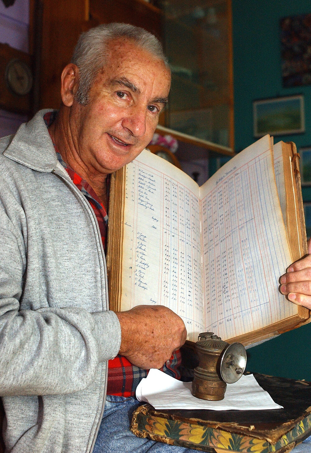 Tom Verrall holding a book on historic mining projects, Ipswich, August 2003