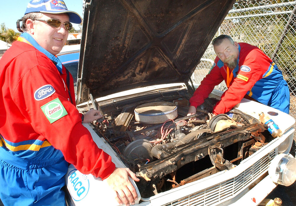 Russell Warneke makes final adjustments as Chris Allison (both of Brisbane) looks on at the start of the Variety Bash, Lowood, August 2003