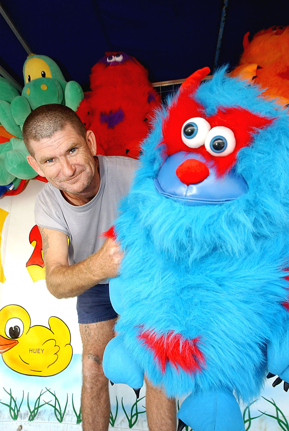 Unidentified man with prize toys at the Ipswich show, Ipswich, May 2003
