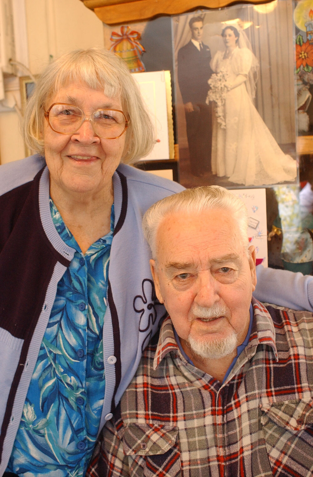 George and Patricia Tanzer in front of a photograph from their wedding, Ipswich, May 2003