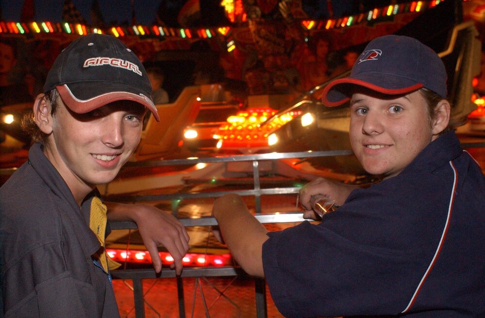 Two unidentified men watching an amusement park rides, Ipswich, May 2003