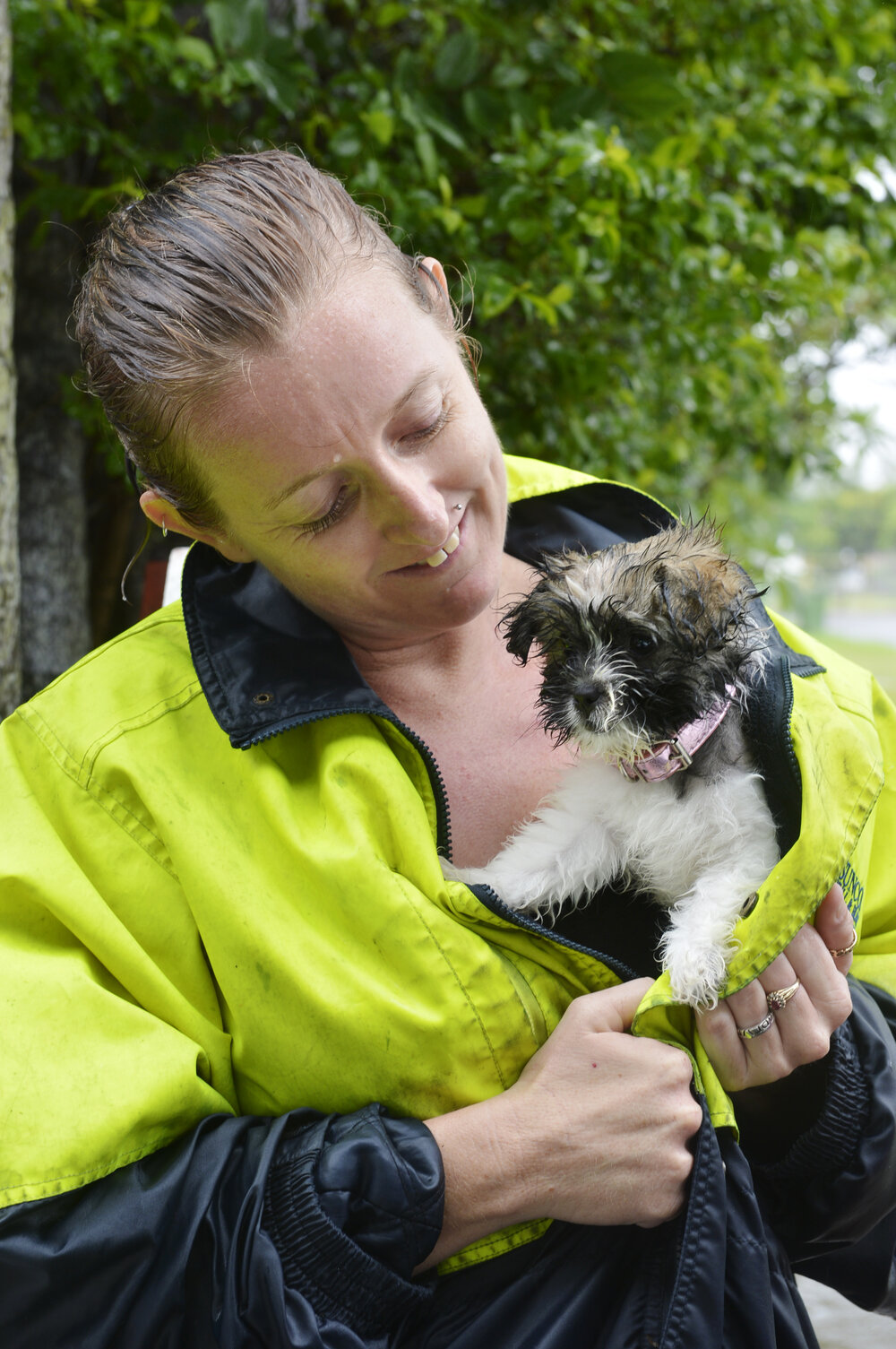 Amelia Jago with puppy Phoebe during heavy rain, Ipswich, January 2013
