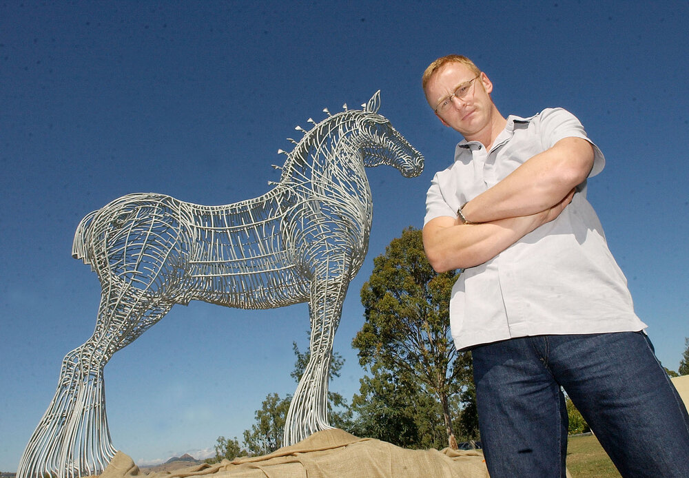 Unidentified man next to horse sculpture, Ipswich, May 2003