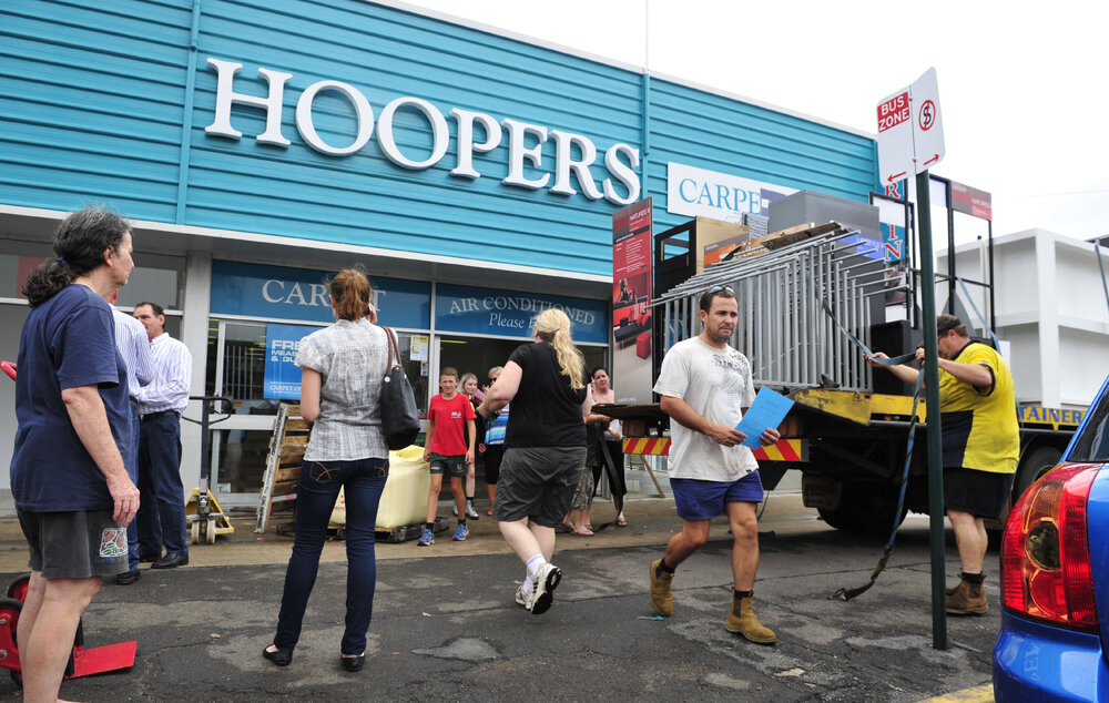 Removing stock from Hoopers Carpet One, as flood waters rise, Brisbane Street, Ipswich, January 2013