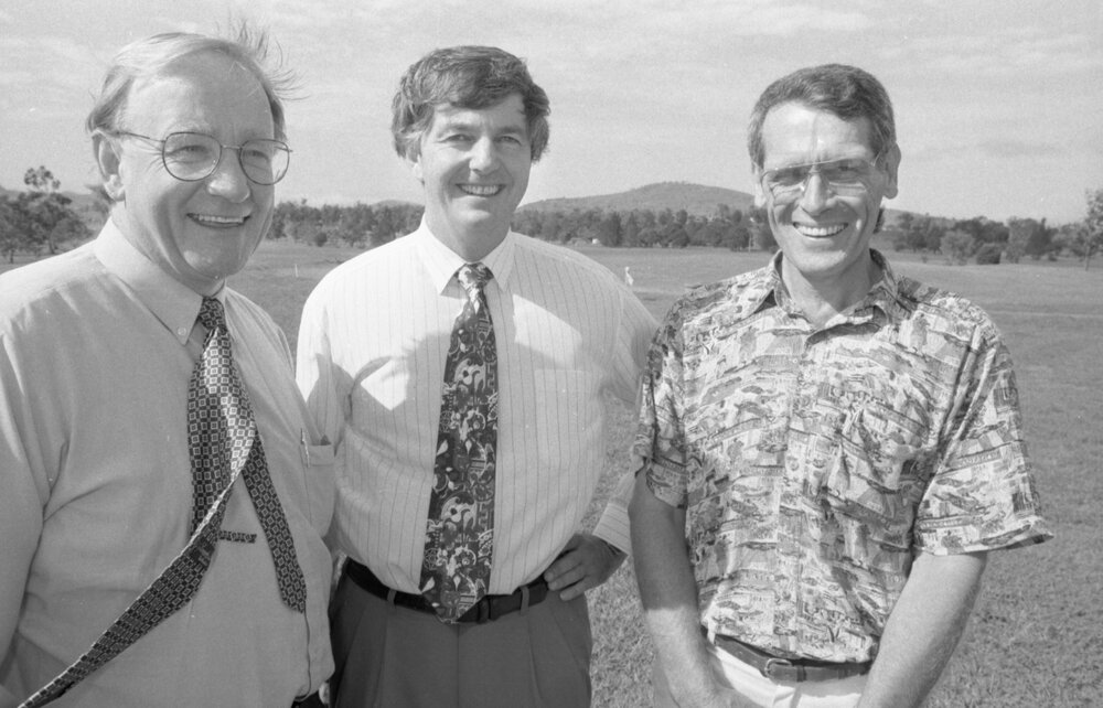 Three unidentified men standing in a paddock, Ipswich, March 1995