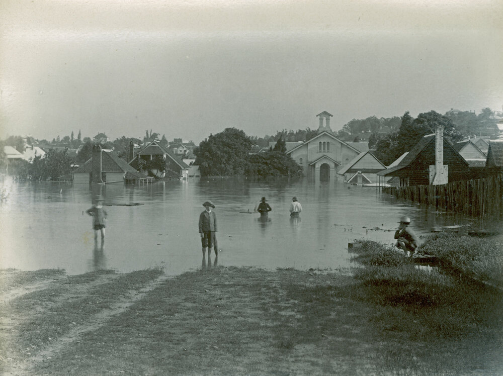 Children standing in flood waters, on Brisbane Street, with Congregational Church in background, believed to be during the flood in Ipswich, 1893