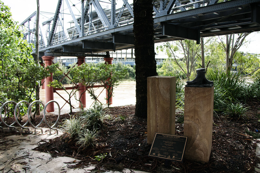 The monument to the 2011 "Mud Army", with the Bremer River in flood behind, Riverheart Parklands, Ipswich, March 2025