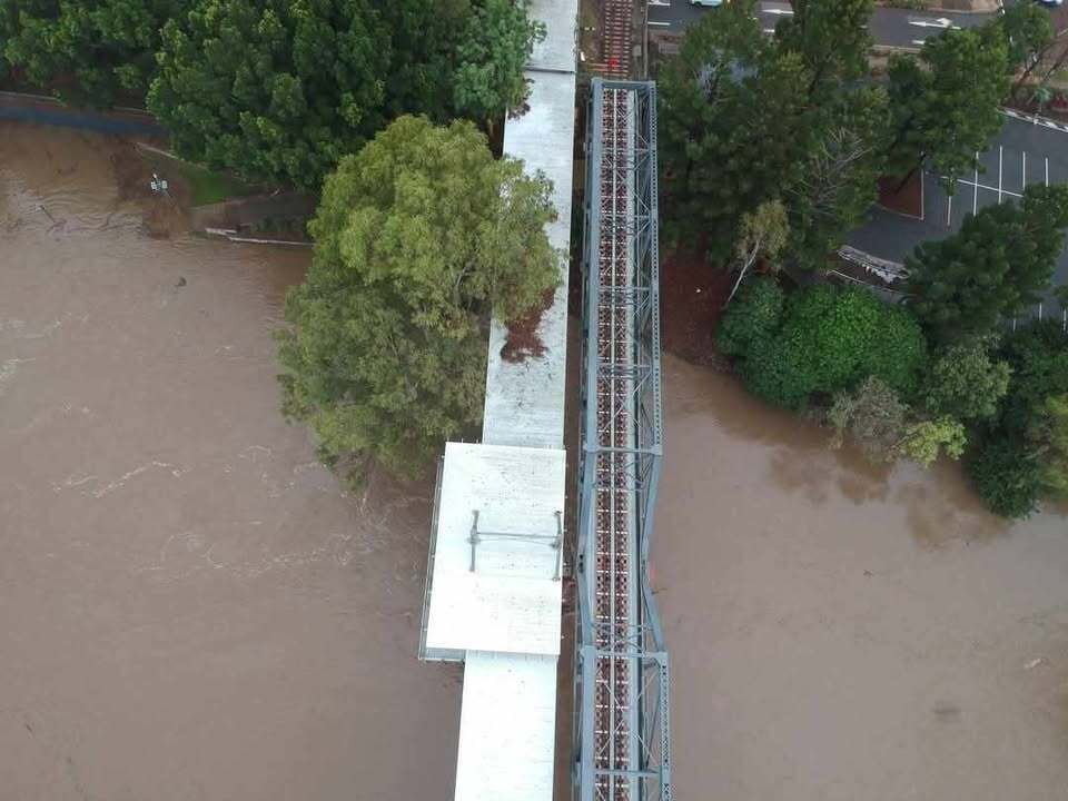 Drone images of the Bremer River in flood under railway and Bradfield bridges, Ipswich, March 2025