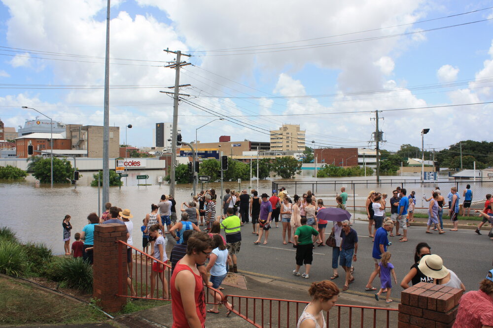 Spectators, on Limestone Street, looking at the Bremer River as it floods Gordon Street and surrounding businesses, Ipswich, January 2011