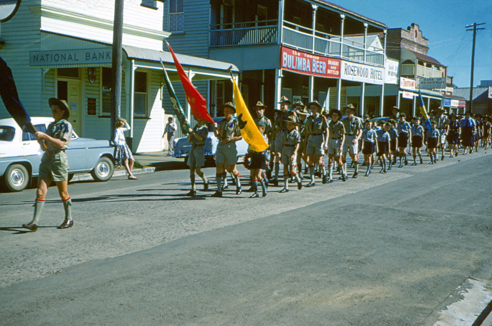 Boy scouts and girl guides during ANZAC Day parade, Rosewood, Ipswich, 1960s